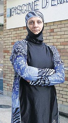 Angry Muslim convert in her shroud suit