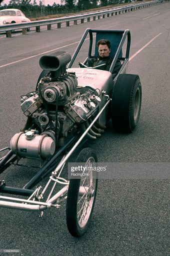 1961 A driver prepares for drag racink